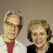Man with gray hair & glasses and smiling woman with blonde hair